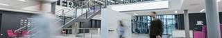 Corporate office real estate modern entryway with staff walking