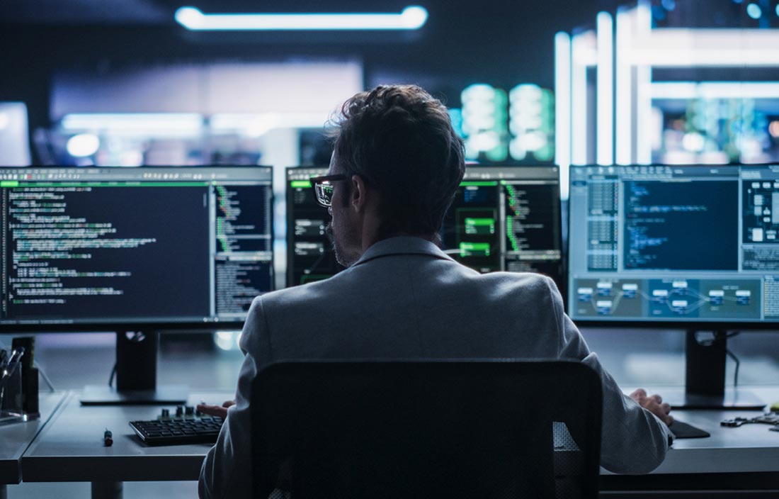 Cybersecurity professional working at their computer.