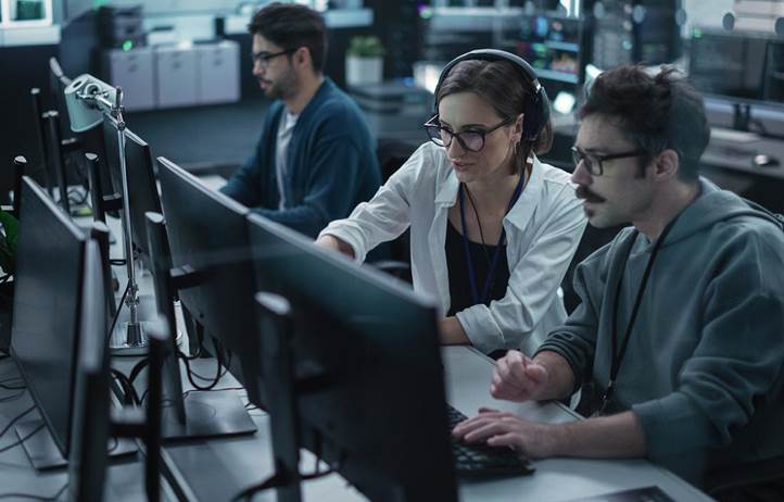 Cybersecurity professionals looking at their computer screen.