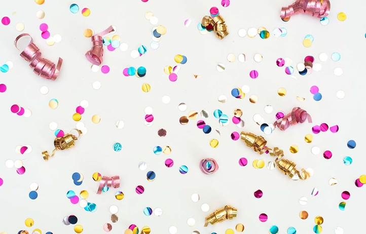 A close up of celebration confetti with a white background